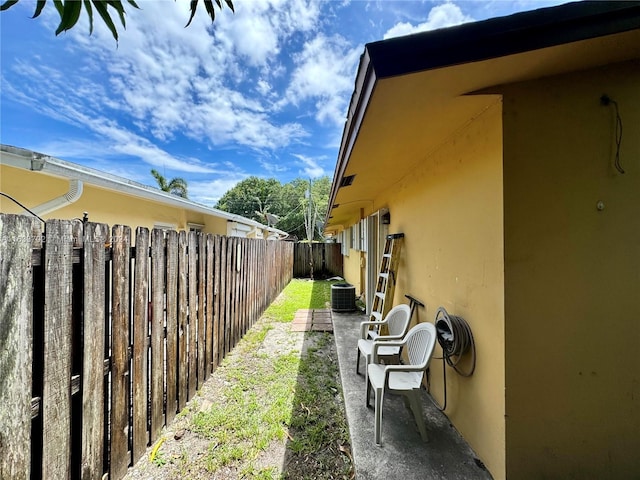 view of yard with central AC and a patio area