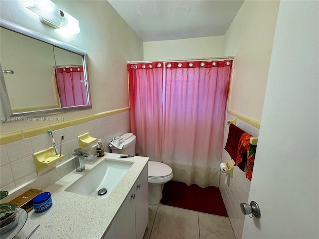 bathroom with backsplash, tile patterned floors, vanity, and tile walls