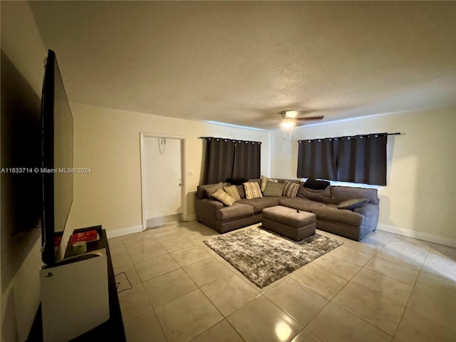 tiled living room featuring a textured ceiling and ceiling fan