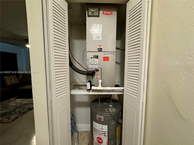 utility room featuring electric water heater and heating unit