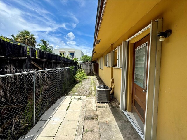 view of side of home featuring central AC