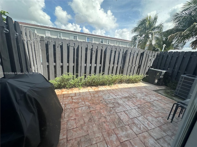 view of patio / terrace featuring central AC unit and grilling area