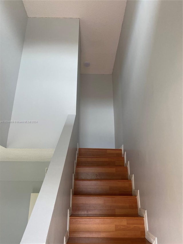 stairs with wood-type flooring