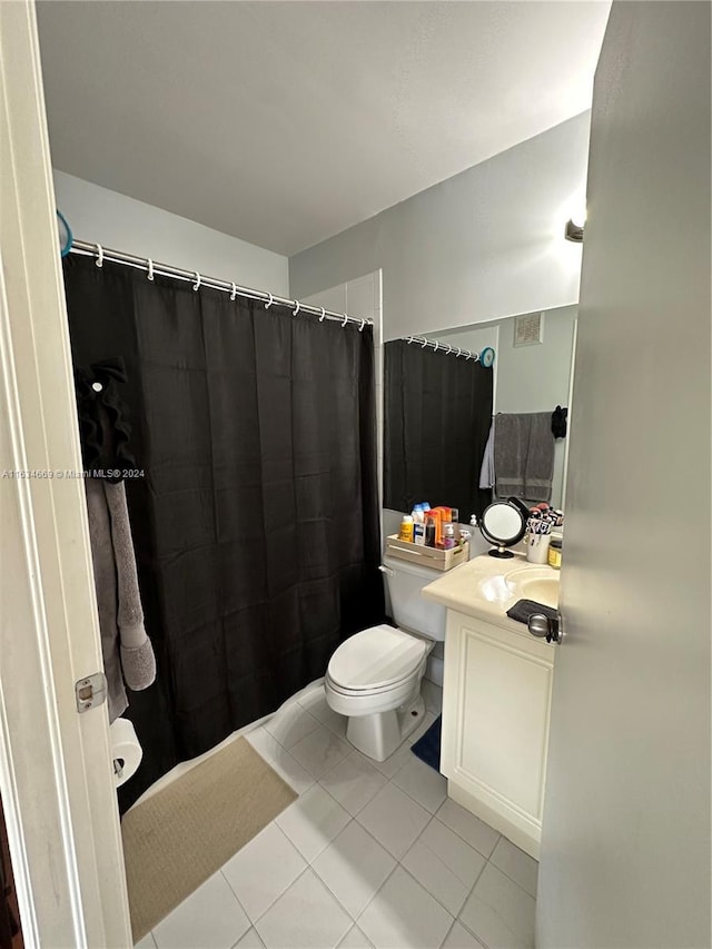 bathroom featuring tile patterned flooring, vanity, toilet, and a shower with curtain