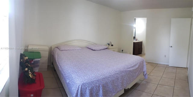 tiled bedroom featuring ensuite bathroom