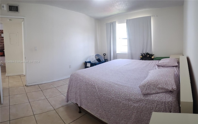 bedroom with light tile patterned floors