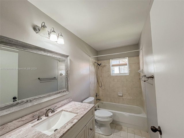 full bathroom with tiled shower / bath combo, tile patterned floors, toilet, and vanity