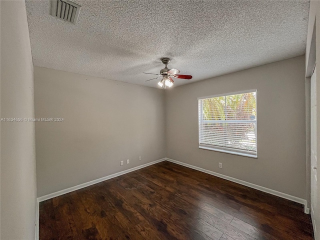 empty room with a textured ceiling, ceiling fan, and hardwood / wood-style floors