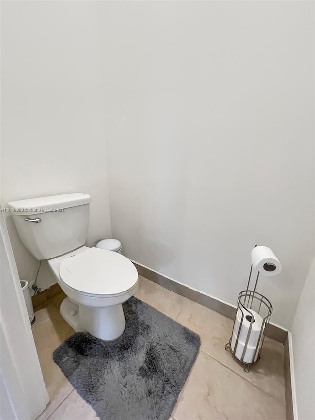 bathroom featuring tile patterned flooring and toilet