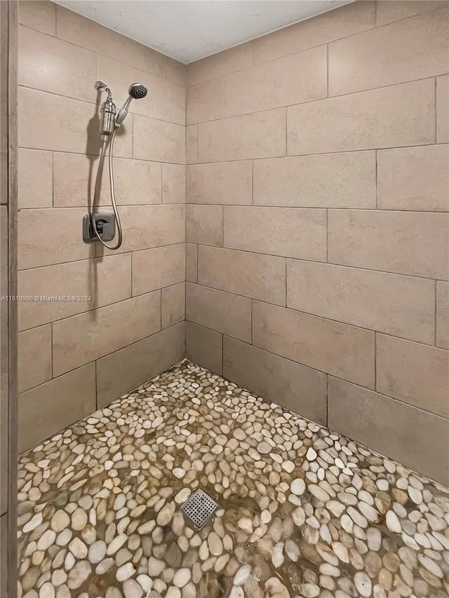 bathroom with tiled shower