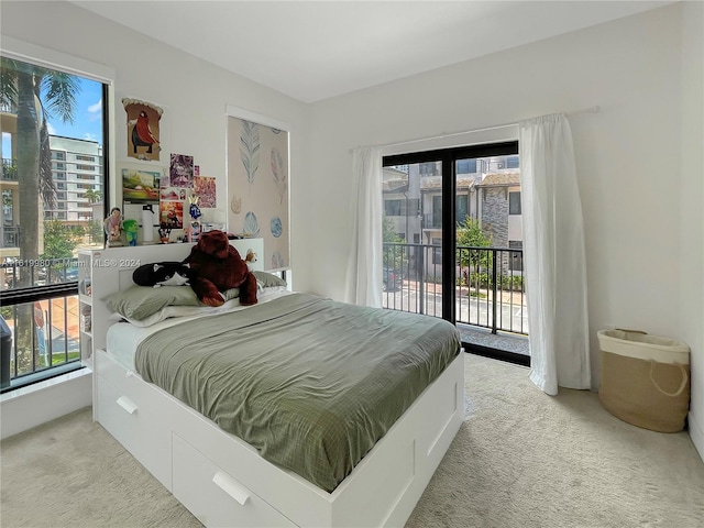 bedroom featuring access to outside, multiple windows, and carpet