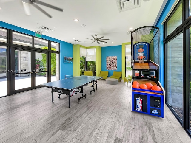 rec room featuring ceiling fan, french doors, and light hardwood / wood-style flooring