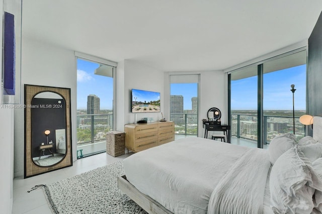 bedroom featuring expansive windows and light tile patterned floors