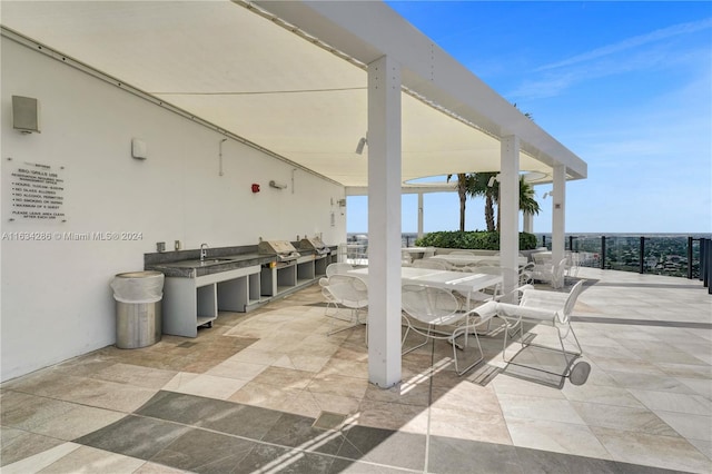 view of patio featuring sink and an outdoor kitchen