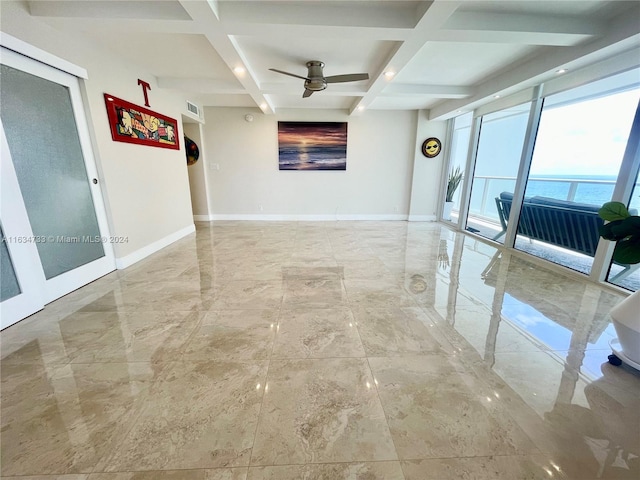 interior space featuring coffered ceiling, a water view, and beamed ceiling