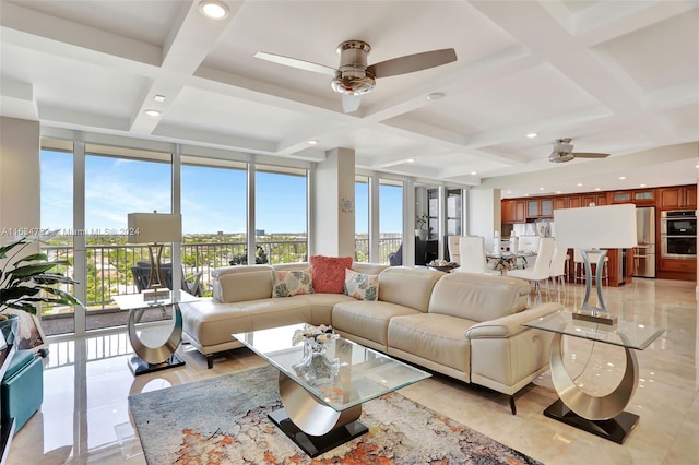 living room featuring ceiling fan, coffered ceiling, expansive windows, and beam ceiling