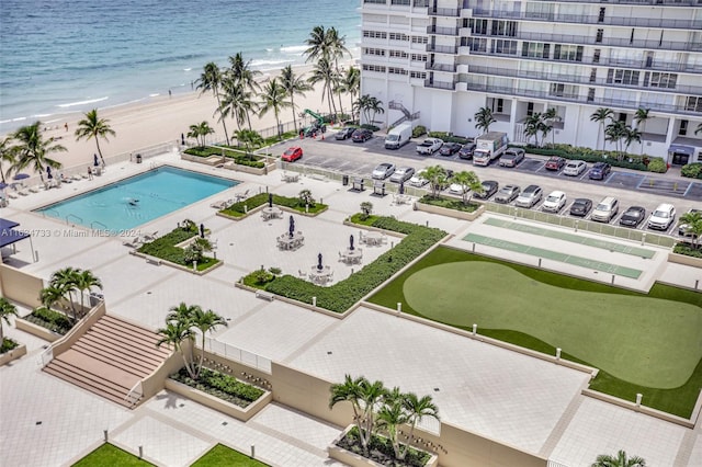 birds eye view of property with a beach view and a water view