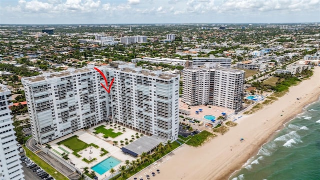 birds eye view of property featuring a view of the beach and a water view