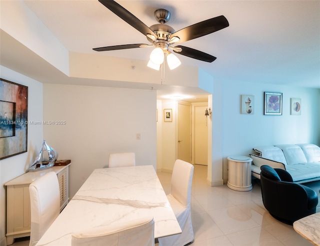 dining area featuring light tile patterned floors and ceiling fan