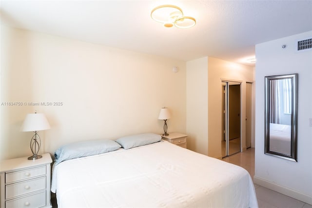 tiled bedroom featuring a closet