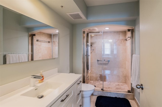 bathroom featuring vanity, toilet, and a shower with door