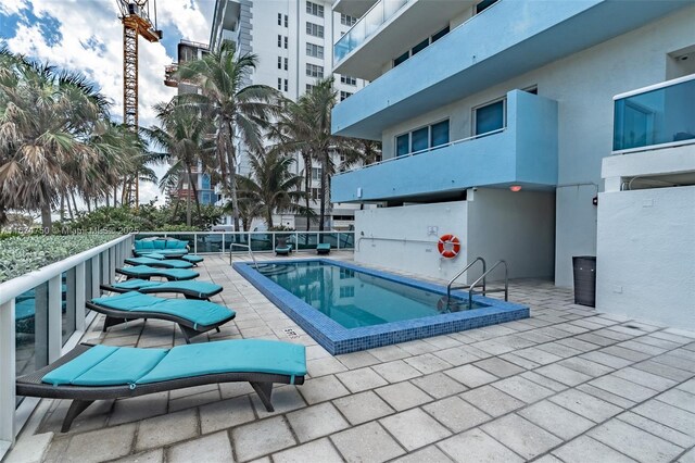 view of swimming pool with a patio