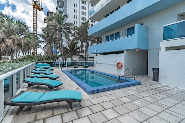 view of swimming pool with a patio area