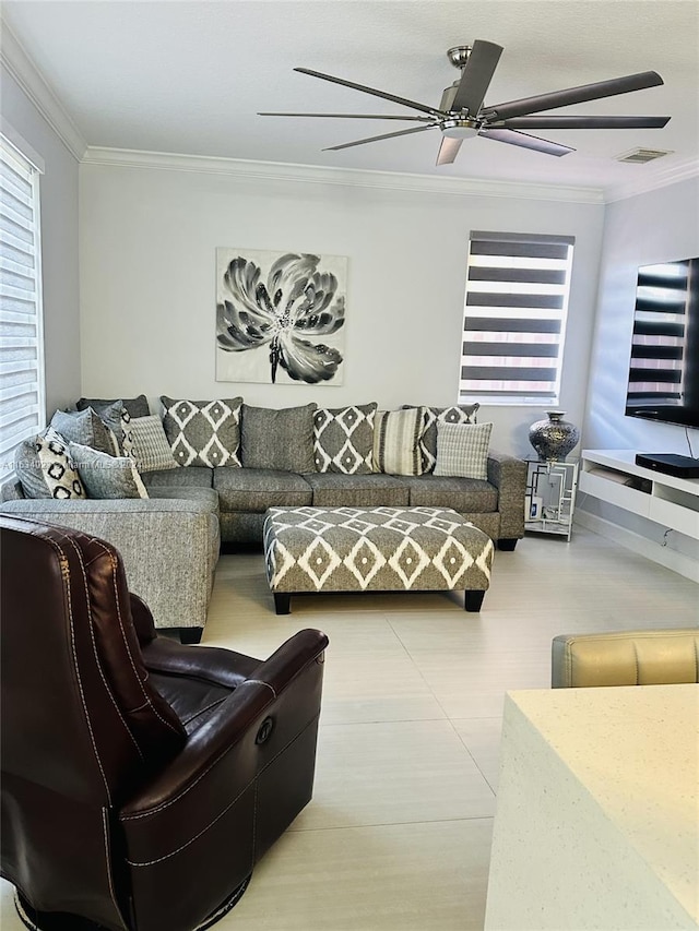 living room with ornamental molding and ceiling fan