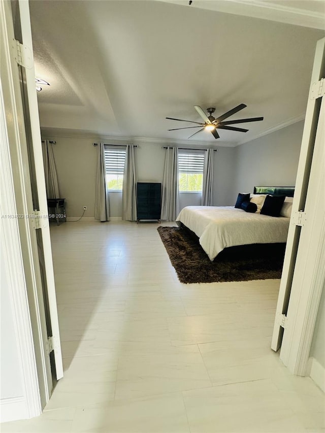 tiled bedroom featuring crown molding and ceiling fan