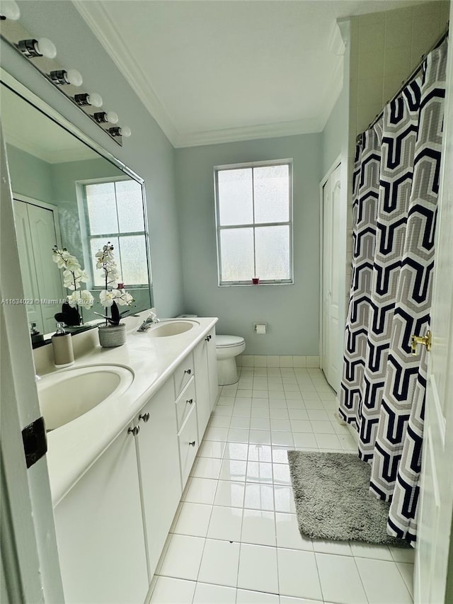 bathroom featuring double vanity, tile patterned flooring, toilet, and plenty of natural light