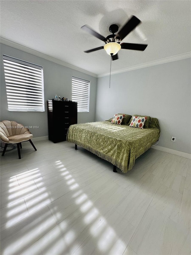 bedroom featuring a textured ceiling, crown molding, and ceiling fan