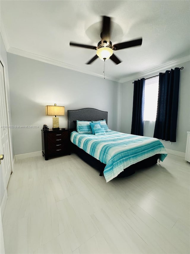 bedroom with ornamental molding and ceiling fan