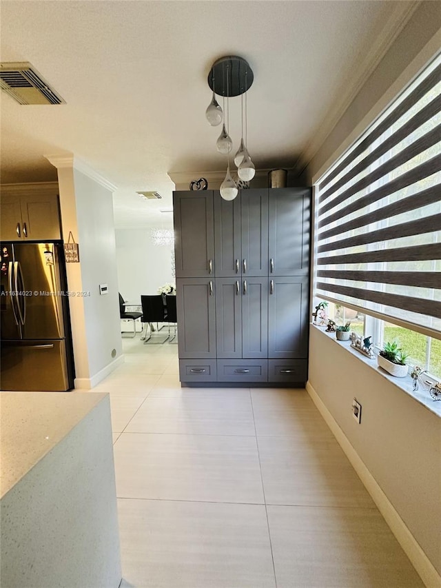 dining area featuring light tile patterned floors and crown molding