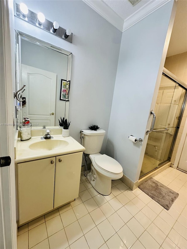 bathroom featuring tile patterned flooring, walk in shower, toilet, vanity, and ornamental molding