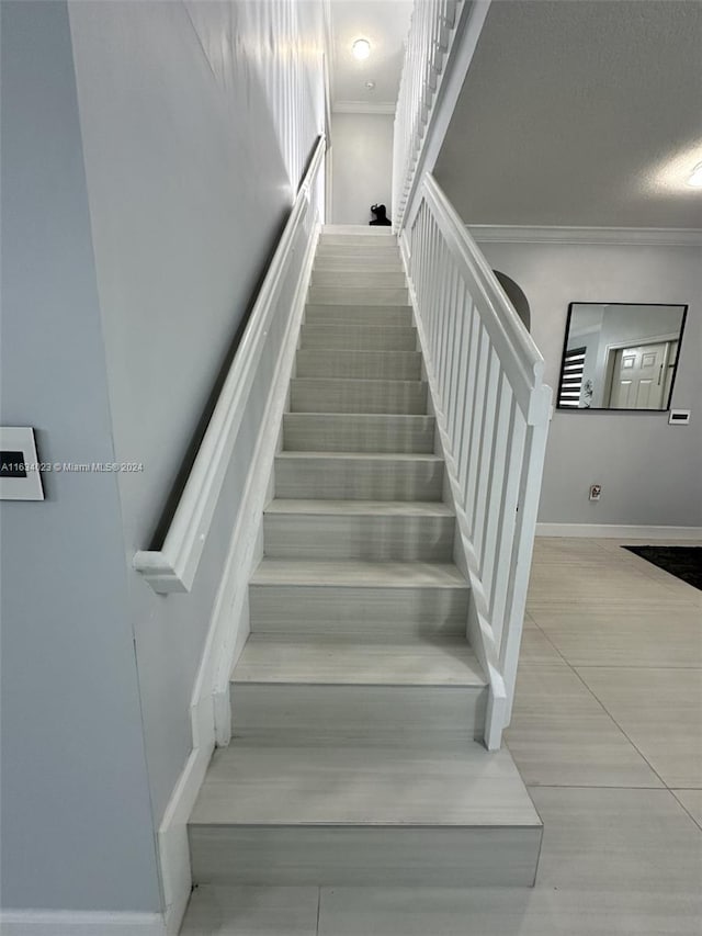 stairway featuring crown molding