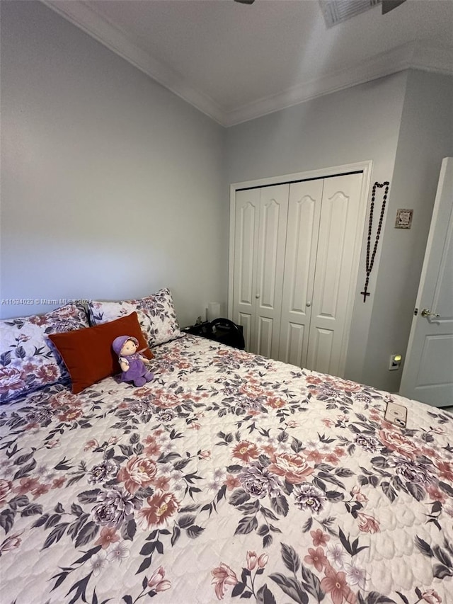 bedroom featuring ornamental molding and a closet