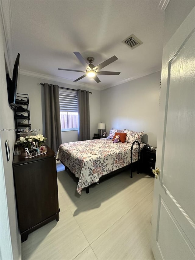 tiled bedroom featuring ceiling fan and crown molding