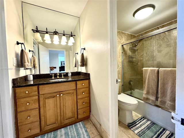 full bathroom featuring vanity, toilet, tile patterned flooring, and combined bath / shower with glass door