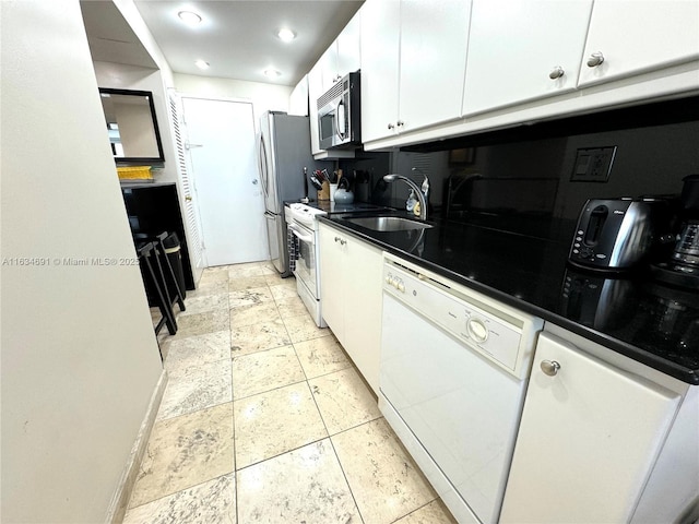 kitchen featuring stainless steel appliances, white cabinetry, sink, and decorative backsplash