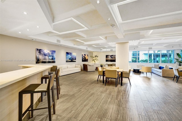 interior space with coffered ceiling, beam ceiling, and light hardwood / wood-style flooring