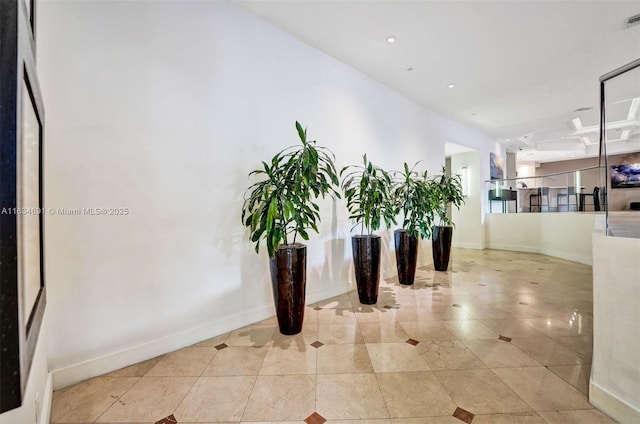 hall featuring light tile patterned floors