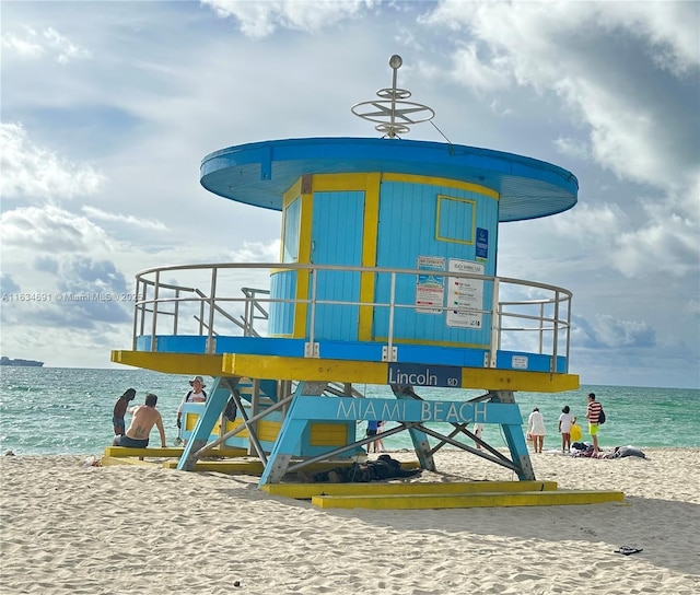 view of play area featuring a beach view and a water view