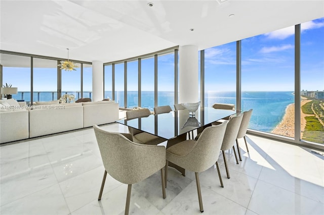 sunroom featuring a water view