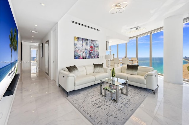 tiled living room with a water view and expansive windows