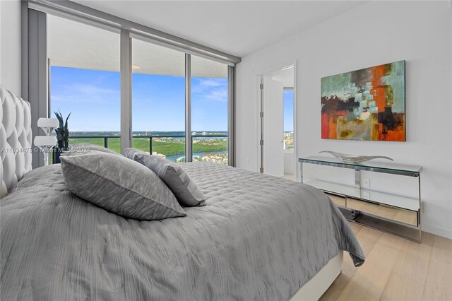 bedroom with light hardwood / wood-style flooring and multiple windows