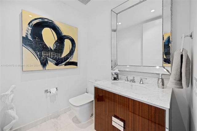 bathroom with vanity, toilet, and tile patterned flooring