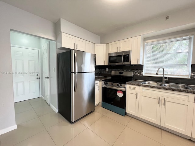 kitchen featuring white cabinetry, light tile patterned flooring, stainless steel appliances, and sink