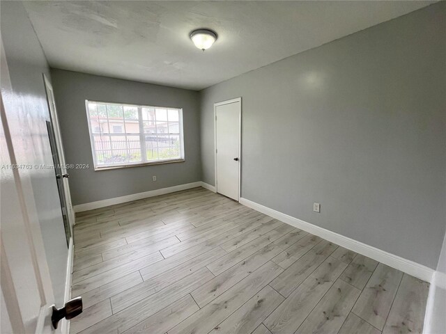 spare room with light wood-type flooring