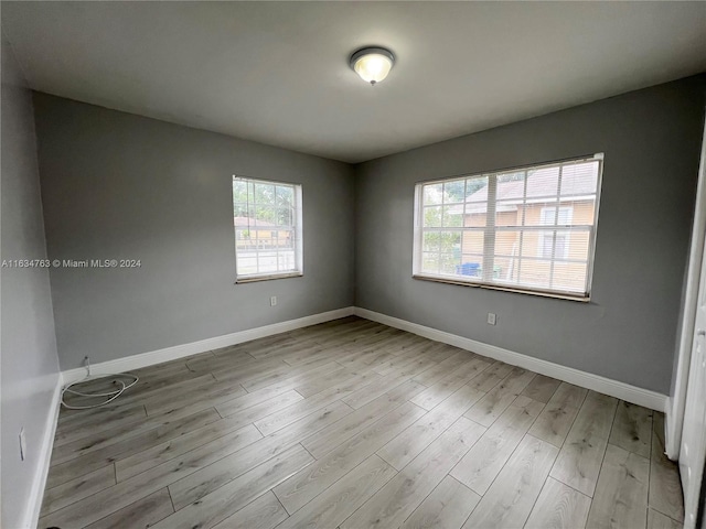 spare room with wood finished floors and baseboards