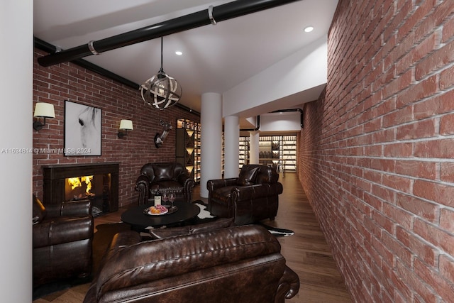 living room featuring a multi sided fireplace, brick wall, and hardwood / wood-style floors